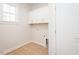Bright laundry room features overhead cabinets, wood flooring, and utility connections at 3402 St Barts Pl, Mebane, NC 27302