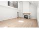 Open-concept living room with tall fireplace, hardwood floors, and staircase at 3402 St Barts Pl, Mebane, NC 27302