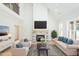 Bright living room with vaulted ceilings, stone fireplace, and stylish furnishings, creating a comfortable space at 3402 St Barts Pl, Mebane, NC 27302