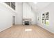 Bright open-concept living room features fireplace, large windows, and hardwood floors at 3402 St Barts Pl, Mebane, NC 27302