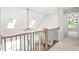An open loft area featuring natural light and modern railing at 3402 St Barts Pl, Mebane, NC 27302