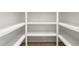 Spacious walk-in pantry with ample shelving for organized storage and easy access at 3402 St Barts Pl, Mebane, NC 27302