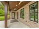 Covered patio with brick columns features a ceiling fan and outdoor rug at 3402 St Barts Pl, Mebane, NC 27302