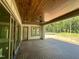 A covered back porch includes wood ceiling and composite flooring that provides beautiful outdoor living space at 316 Firefly Overlook, Pittsboro, NC 27312