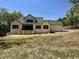 Rear exterior of the home shows a large deck, windows, and unfinished yard with an in-ground sprinkler system at 316 Firefly Overlook, Pittsboro, NC 27312