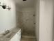 Modern bathroom features a tiled shower, vanity, and brushed bronze fixtures at 316 Firefly Overlook, Pittsboro, NC 27312