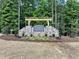 Stone entrance sign for Firefly Overlook at Jordan Lake, featuring lush landscaping and a welcoming pergola at 316 Firefly Overlook, Pittsboro, NC 27312