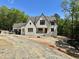 New construction exterior showcasing white painted brick, charming architectural details and a grey roof at 316 Firefly Overlook, Pittsboro, NC 27312