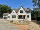 Striking two-story white brick home with gable roof and inviting front porch at 316 Firefly Overlook, Pittsboro, NC 27312