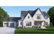 Beautiful two-story home with a brick and siding exterior, featuring a landscaped front yard and attached garage at 316 Firefly Overlook, Pittsboro, NC 27312
