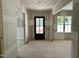 An unfinished foyer featuring a wooden front door, side windows, and open access to adjacent rooms at 316 Firefly Overlook, Pittsboro, NC 27312
