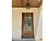 Elegant wood front door with glass panels and sleek hardware at 316 Firefly Overlook, Pittsboro, NC 27312
