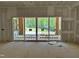 Bright living room with large sliding glass doors and an unfinished deck, offering indoor-outdoor living at 316 Firefly Overlook, Pittsboro, NC 27312