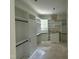 Bright, large walk-in closet with custom built-in shelving, drawers, and hanging racks at 316 Firefly Overlook, Pittsboro, NC 27312