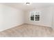 A carpeted bedroom bathed in natural light from a window that overlooks a nearby house at 4466 Debnam Rd, Zebulon, NC 27597