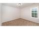 Bedroom featuring carpeted floor and a bright window at 4466 Debnam Rd, Zebulon, NC 27597