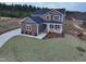 Stunning exterior of home with well-maintained lawn and cozy front porch at 4466 Debnam Rd, Zebulon, NC 27597
