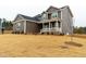 Charming two-story home with mixed siding, a covered porch, and a landscaped yard at 4466 Debnam Rd, Zebulon, NC 27597