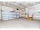 Spacious two-car garage with an overhead door and access door to the home's interior at 4466 Debnam Rd, Zebulon, NC 27597