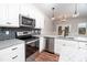 Well-equipped kitchen featuring stainless steel appliances, subway tile, and granite counters at 4466 Debnam Rd, Zebulon, NC 27597