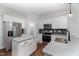 Modern kitchen with stainless steel appliances, granite countertops, and white cabinetry at 4466 Debnam Rd, Zebulon, NC 27597
