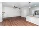 Spacious living room featuring hardwood floors, ceiling fan, and an open floor plan to the kitchen area at 4466 Debnam Rd, Zebulon, NC 27597