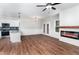 Open-concept living space with fireplace, wood floors, and abundant natural light at 4466 Debnam Rd, Zebulon, NC 27597