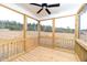Relaxing screened-in porch features wood flooring, ceiling fan, and scenic views at 4466 Debnam Rd, Zebulon, NC 27597