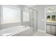 Bathroom with soaking tub, glass shower, and modern fixtures at 21 Walnut Hall Ct, Selma, NC 27576