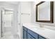 Bathroom with blue vanity and a large mirror at 21 Walnut Hall Ct, Selma, NC 27576
