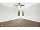 Bright bedroom featuring two windows and a ceiling fan at 21 Walnut Hall Ct, Selma, NC 27576