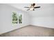 Bright bedroom with ceiling fan and window views at 21 Walnut Hall Ct, Selma, NC 27576