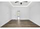 Bright bedroom with wood-look floors and access to a hallway at 21 Walnut Hall Ct, Selma, NC 27576