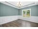 Formal dining room with wainscoting, hardwood floors, and large window at 21 Walnut Hall Ct, Selma, NC 27576