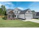 Two-story house with stone accents and two car garage at 21 Walnut Hall Ct, Selma, NC 27576