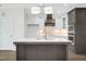Modern kitchen island with white quartz countertops and dark wood cabinets at 21 Walnut Hall Ct, Selma, NC 27576