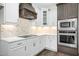 Modern kitchen with stainless steel appliances and geometric backsplash at 21 Walnut Hall Ct, Selma, NC 27576