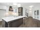 Modern kitchen with large island, stainless steel appliances, and hardwood floors at 21 Walnut Hall Ct, Selma, NC 27576