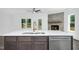 Kitchen island with stainless steel dishwasher and view of a cozy fireplace at 21 Walnut Hall Ct, Selma, NC 27576