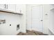 Laundry room with white cabinets, herringbone tile floor, and built-in shelving at 21 Walnut Hall Ct, Selma, NC 27576
