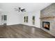 Living room with stone fireplace, hardwood floors, and access to backyard at 21 Walnut Hall Ct, Selma, NC 27576