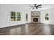 Spacious living room with corner fireplace, hardwood floors, and ceiling fan at 21 Walnut Hall Ct, Selma, NC 27576