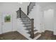 Elegant staircase with dark wood and black metal railing at 21 Walnut Hall Ct, Selma, NC 27576