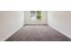Cozy bedroom with plush carpet, bright window, and ample space for furnishings at 83 Artic Circle, Garner, NC 27529