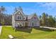 Charming two-story home featuring stone accents, gray siding, white trim, and large windows at 83 Artic Circle, Garner, NC 27529
