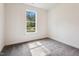 This is a carpeted bedroom featuring a bright window at 83 Artic Circle, Garner, NC 27529
