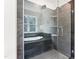 Modern bathroom featuring a bathtub, glass enclosed shower with dual shower heads, and built in shelving at 83 Artic Circle, Garner, NC 27529
