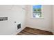 Well-lit laundry room with modern vinyl floors and utility connections at 83 Artic Circle, Garner, NC 27529