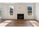 Bright living room with hardwood floors and a cozy fireplace, complemented by natural light at 83 Artic Circle, Garner, NC 27529