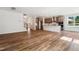 Open-concept living room featuring hardwood floors and a modern kitchen with white island at 83 Artic Circle, Garner, NC 27529